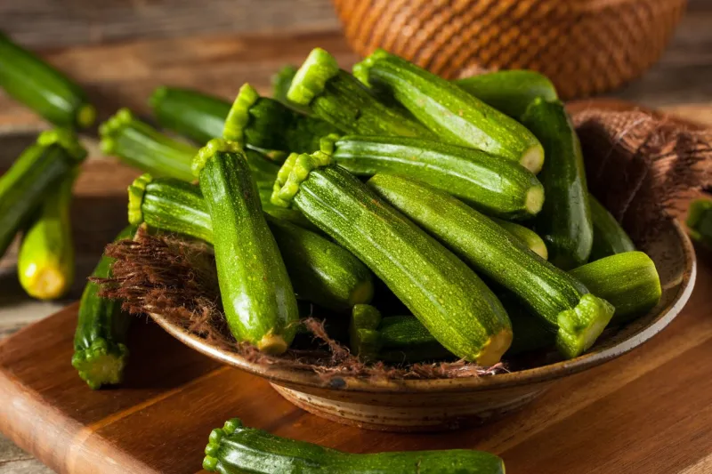raw green organic baby zucchini in a bowl