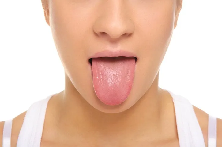 woman stick ones tongue out isolated in white