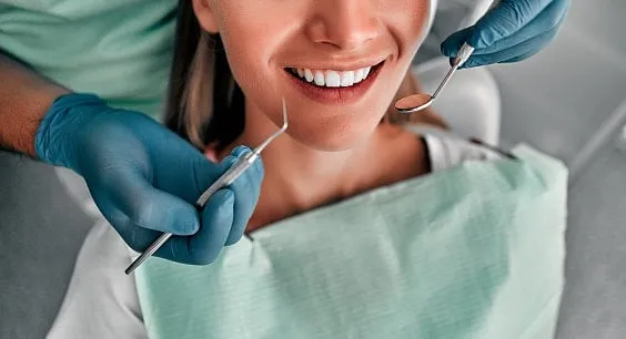 cropped shot of dentist examining teeth of beautiful female client healthy teeth concept