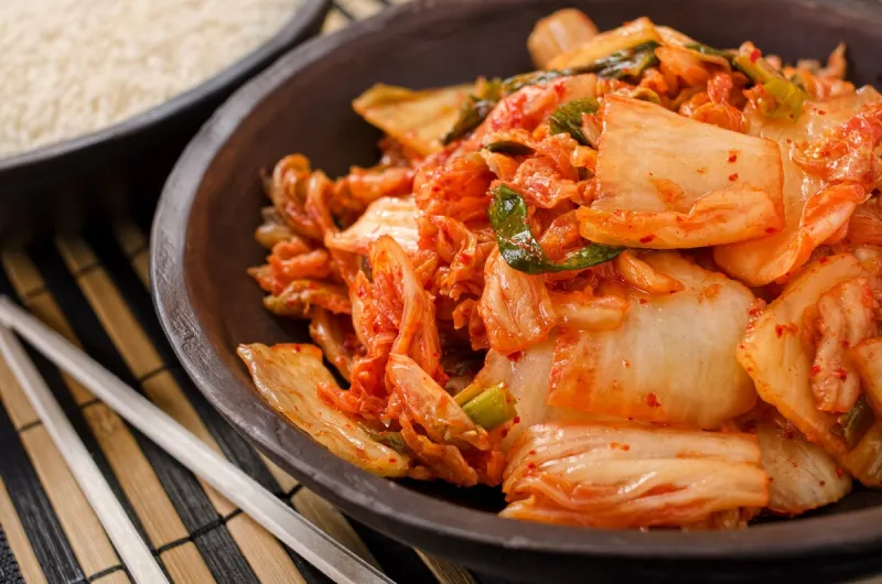 a bowl of traditional korean napa kimchi with white rice