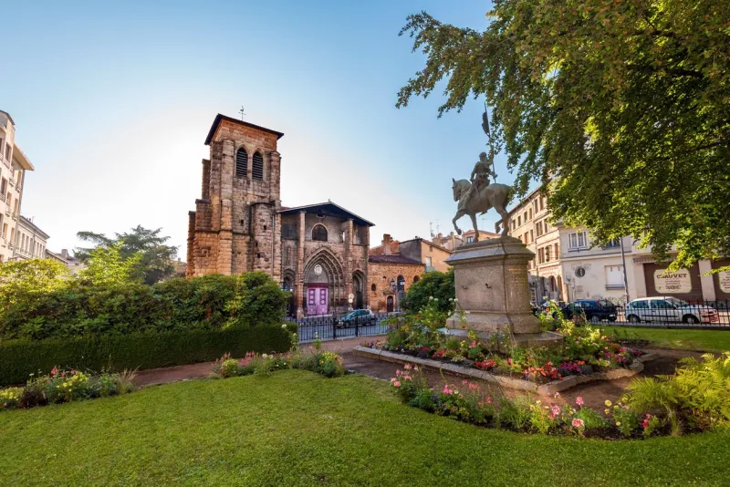 saint-etienne, france- july 29, 2019 saint etienne church as seen from boivin square jean du2019arc monument is at right foreground