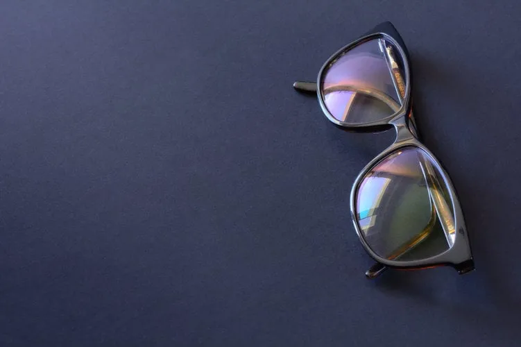 anti-glare coating on the glasses glasses with black frames on a dark background