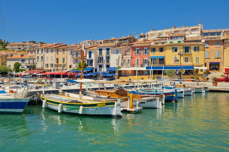 colorful traditional houses and boats in the port of cassis town, france