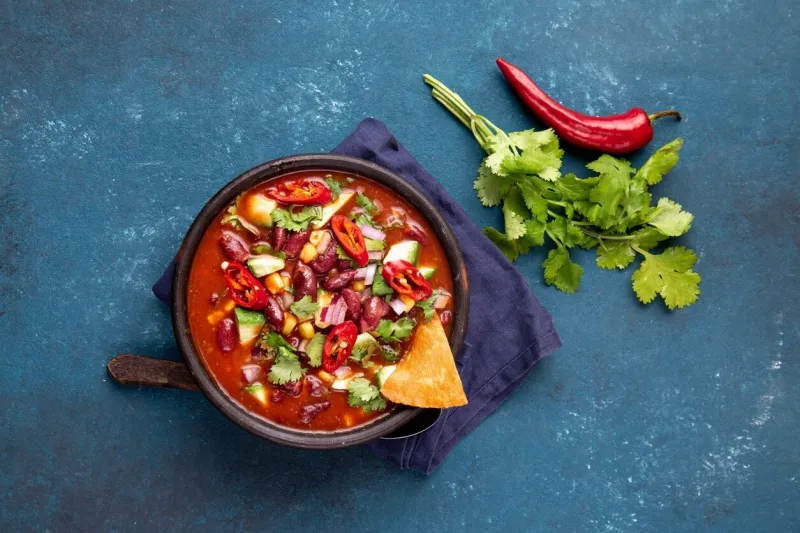 mexican chile bean soup on blue background