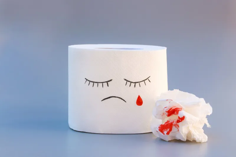 toilet paper and blood concept of hemorrhoid treatment