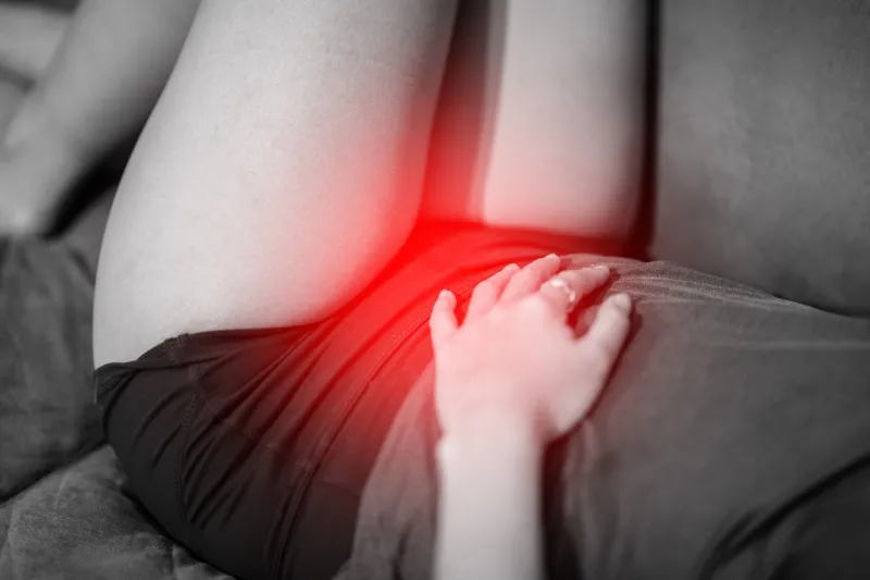 woman have bladder pain or uti pain sitting on bed in bedroom after wake up feeling so illness,healthcare concept