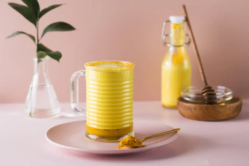 latte turmeric on a pink background moon milk for better sleep ayurvedic drink copy space high quality photo
