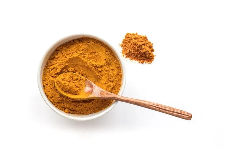 golden turmeric powder concrete background traditional indian spice