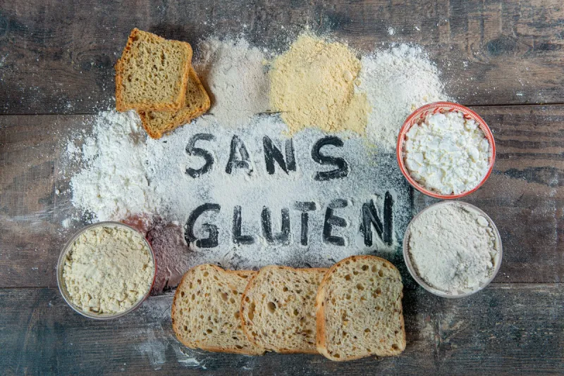 gluten-free (sans gluten) bread and flour on the wooden background