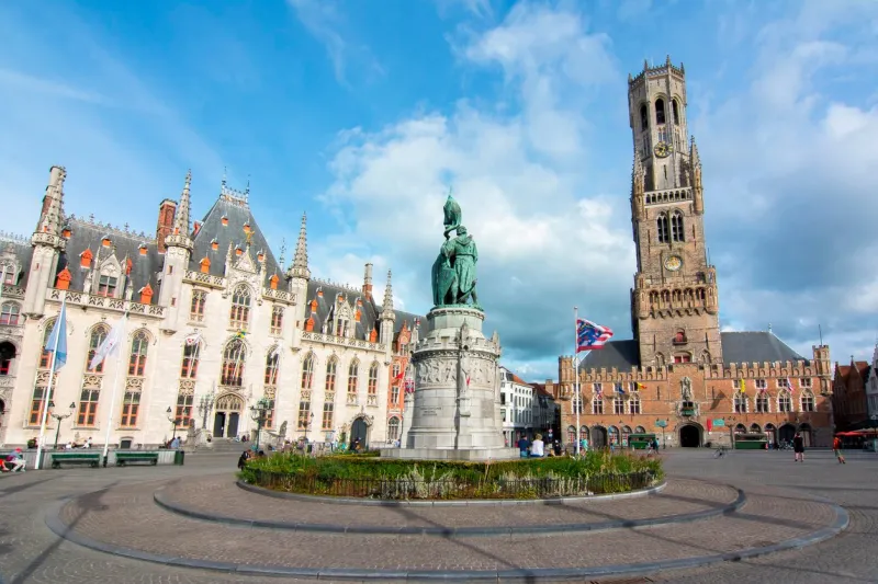 bruges, belgium - july 2017  market square (grote markt) and belfort tower in brugge