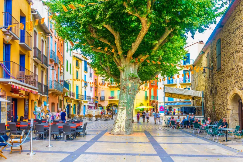 collioure, france, june 27, 2017  people are strolling through a narrow street in the center of collioure, france