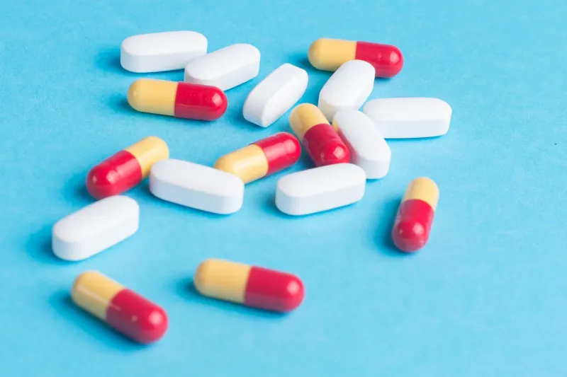 mix of medicines, pills, on a blue background