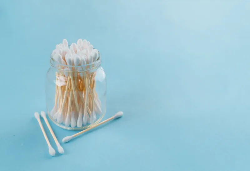 bath set - sponge luffa, bamboo sticks ear on blue background concept less waste