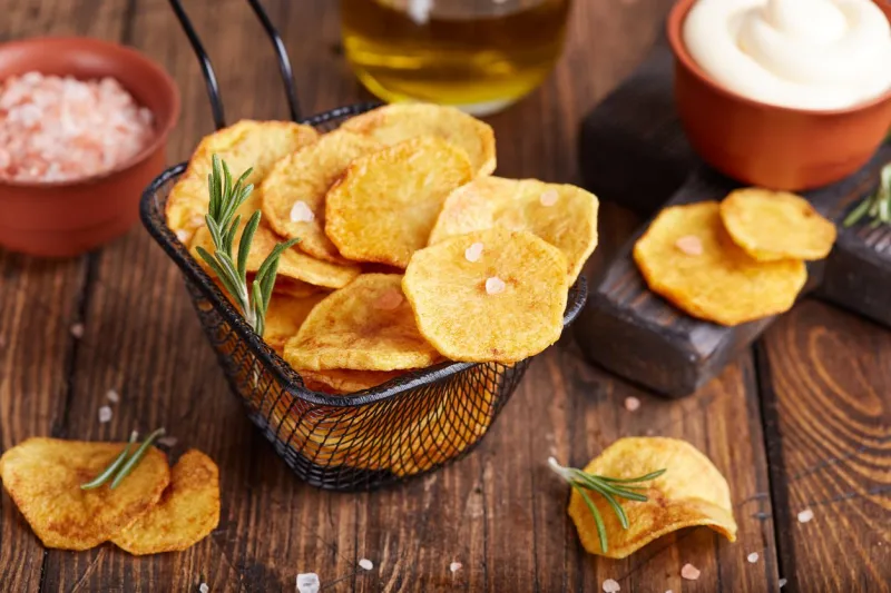 crispy potato chips slices of potato, roasted with sea salt and rosemary delicious snack served with sauce fast food