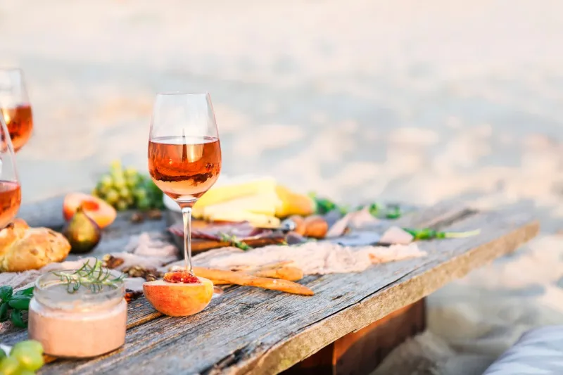 glass of rose wine on rustic table food and drink background