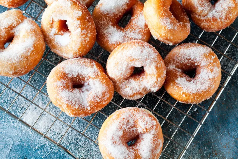 close-up of a bunch of homemade donuts on a cooling tray