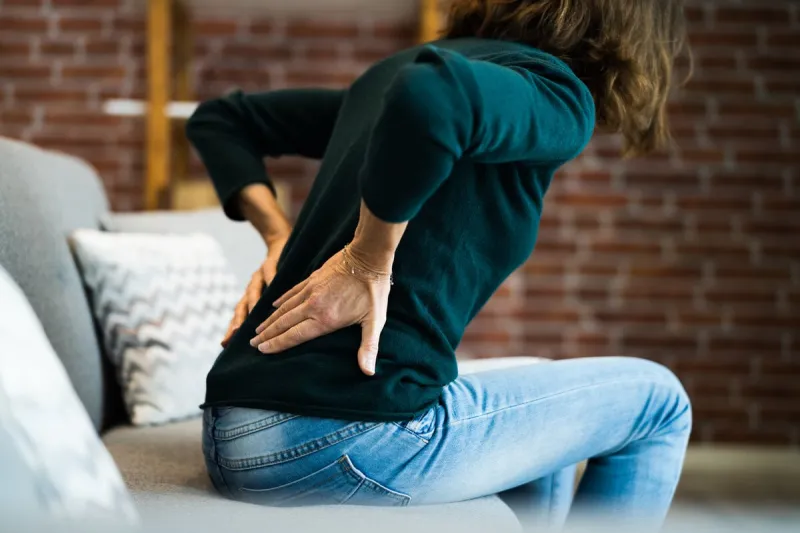 woman with back pain and ache bad posture