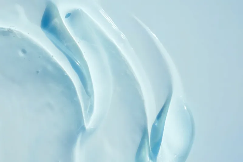 transparent gel texture, cosmetic background textured transparent collagen, serum gel, blue background