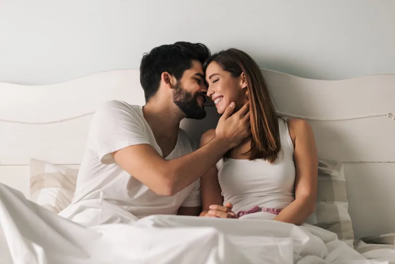 affectionate young couple relaxing in bed and having a romantic moment