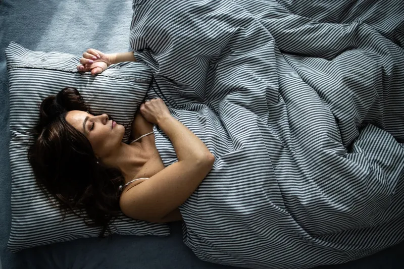 pretty, young woman sleeping in her bed