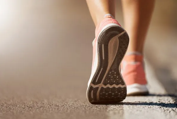 running shoe closeup of woman running on road with sports shoes