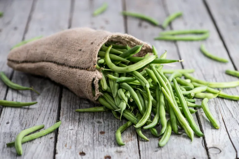 some green beans on wooden background