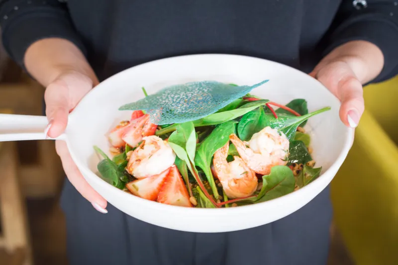 salad plate woman hands hold in a restaurant