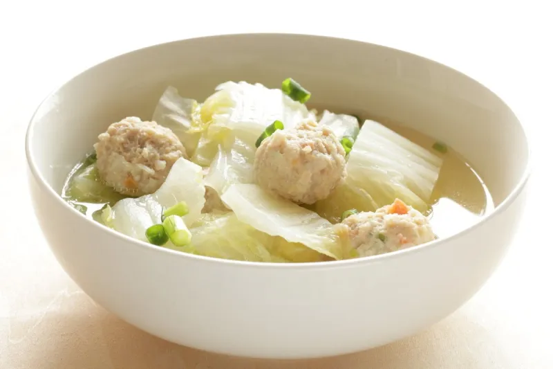 chicken meat ball and chinese cabbage soup in white bowl for wi