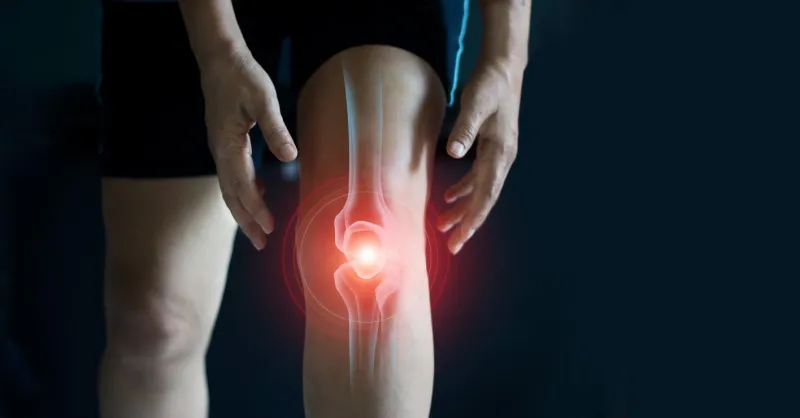 elderly woman suffering from pain in knee tendon problems and joint inflammation on dark background