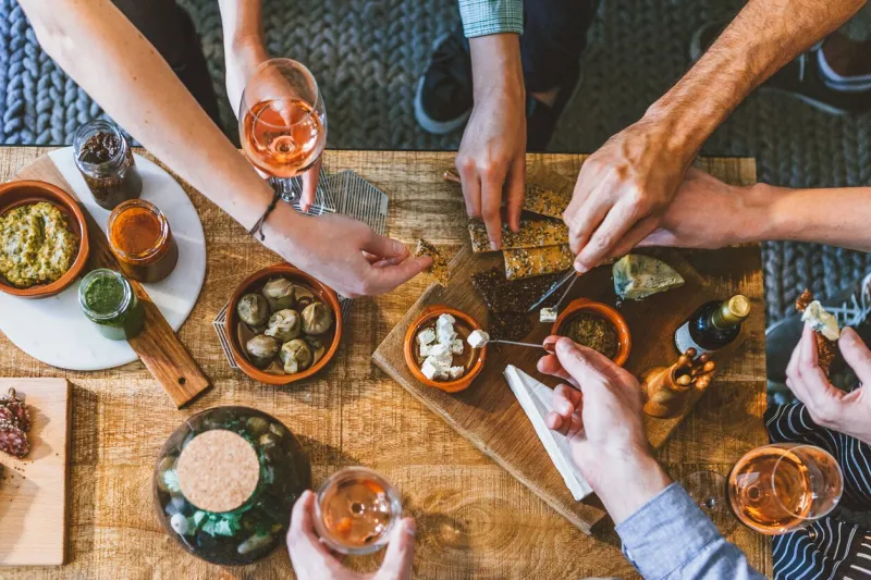 top view of a group of people around a table enjoying food and friendship