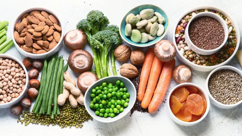 food sources of plant based protein healthy diet with legumes, dried fruit, seeds, nuts and vegetables foods high in protein, antioxidants, vitamins and fiber