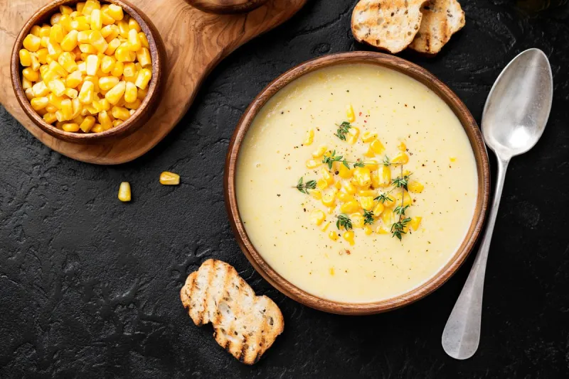 delicious creamy sweetcorn soup served with toast and corn grain