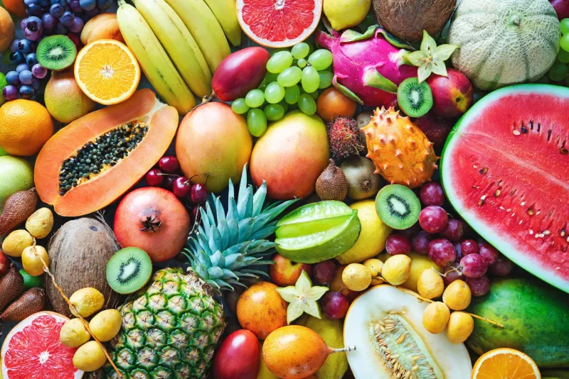 food background assortment of colorful ripe tropical fruits top view