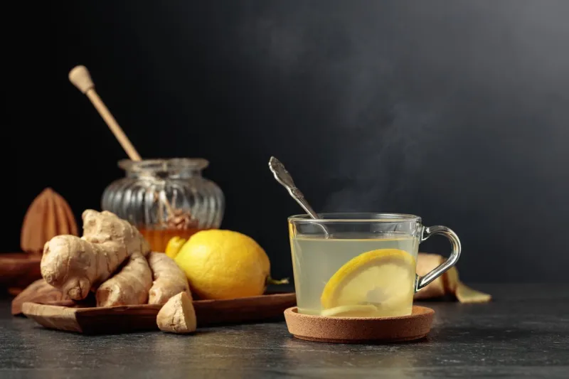 ginger tea with lemon and honey on a black background