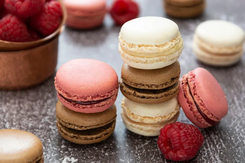 a group of macarons isolated on dark background healthy cake dessert made from almond flour raspberry fruit macaroons cookies