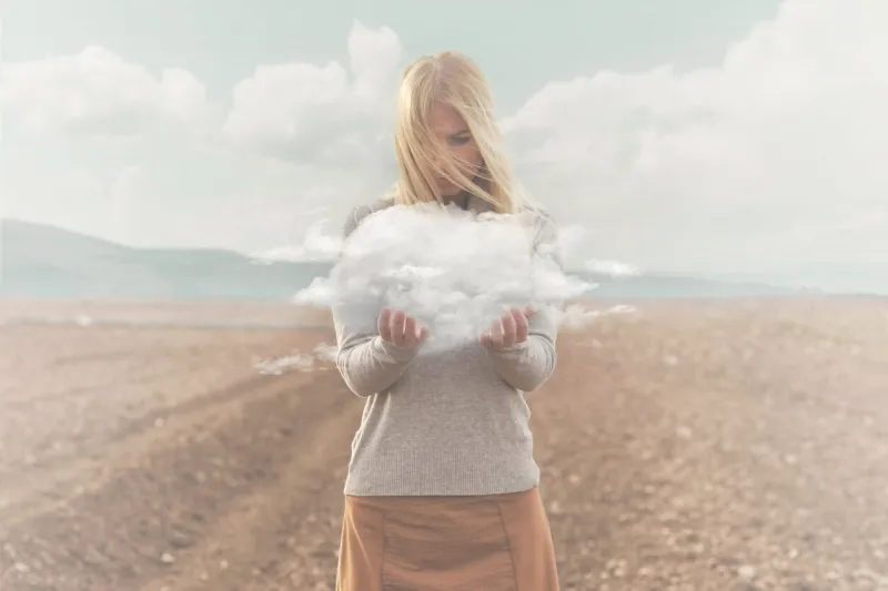 surreal moment , woman holding in her hands a soft cloud