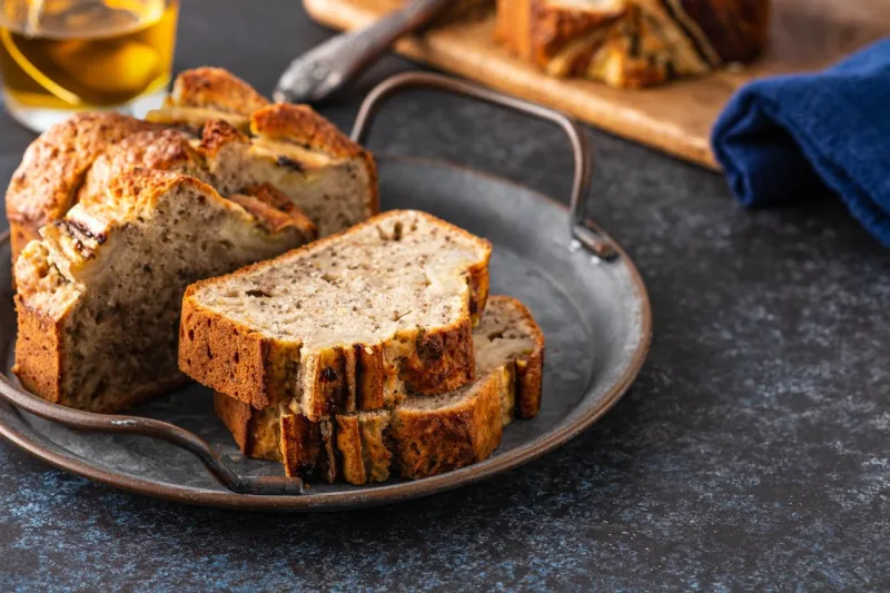 delicious banana bread with walnuts and oats closeup view of sliced banana bread