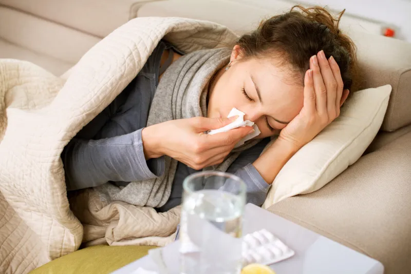 sick woman flu woman caught cold sneezing into tissue