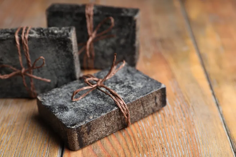 natural tar soap on wooden table, closeup
