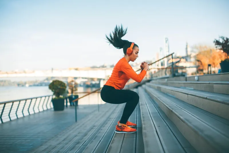 fitness woman jumping outdoor in urban enviroment