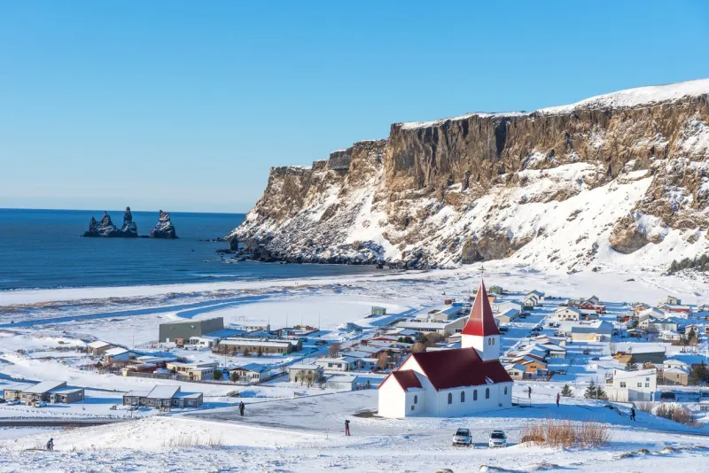 picturesque aerial view of vik i myrdal church at the top of the hill in iceland in winter panoramic beautiful view of village vik and myrdal church in winter in iceland