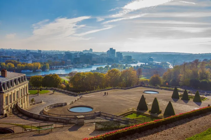 idyllic aerial view on paris   domaine national de saint-cloud and river seine at autumn topiary trees and golden autumn foliage in public park