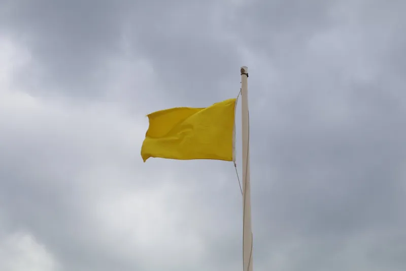 low angle view of flag against cloudy sky