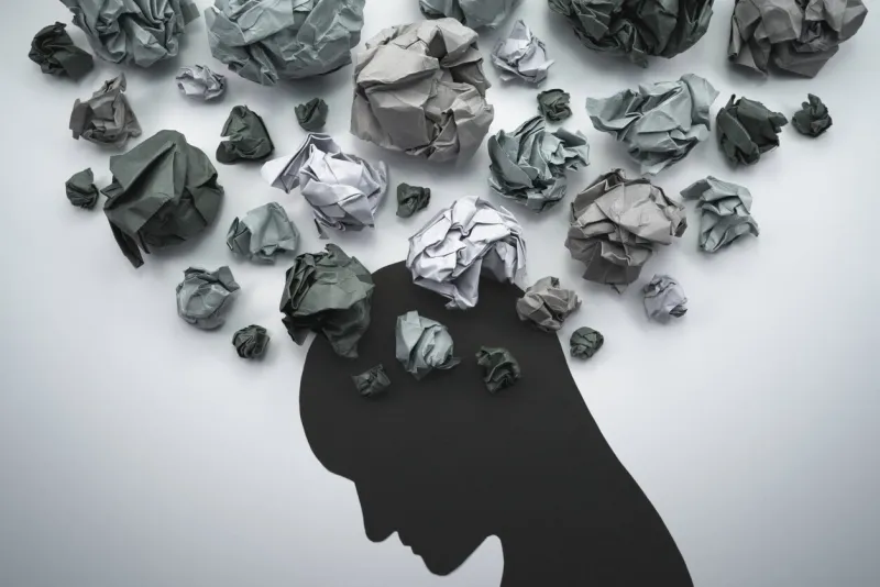 concept image of anxiety and negative emotion waste paper and head silhouette