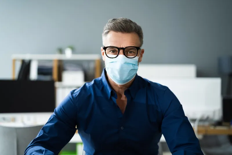 receptionist woman wearing medical mask at office reception