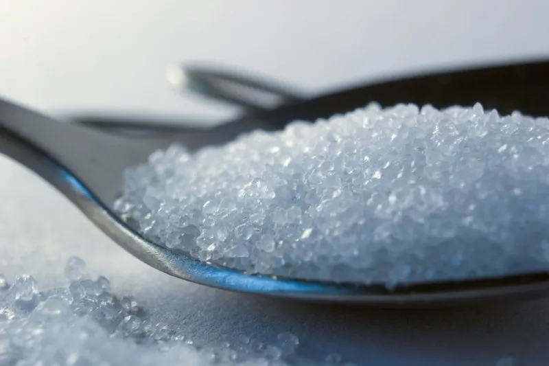 macro of a healthy sea salt on metal spoon closeup
