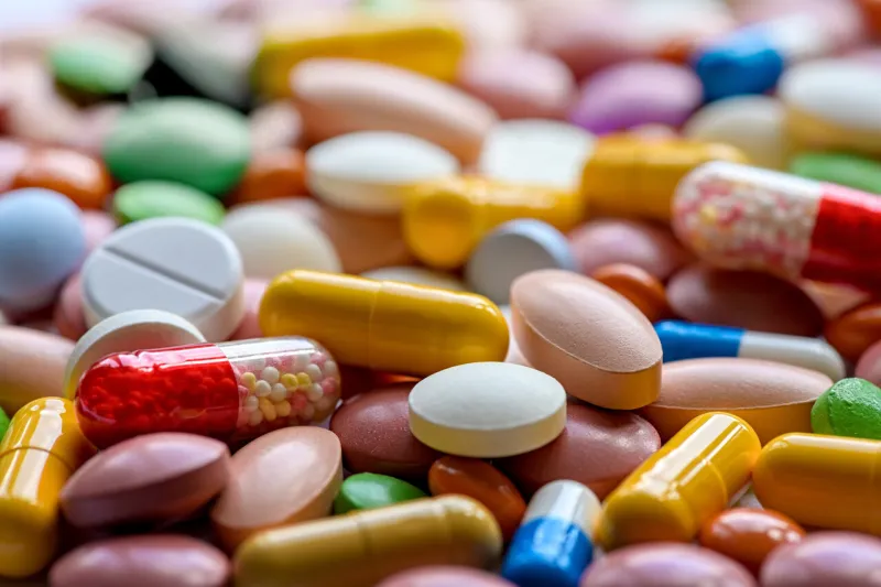 different colorful pills and drugs background medicinal tablets capsules pills selective focus
