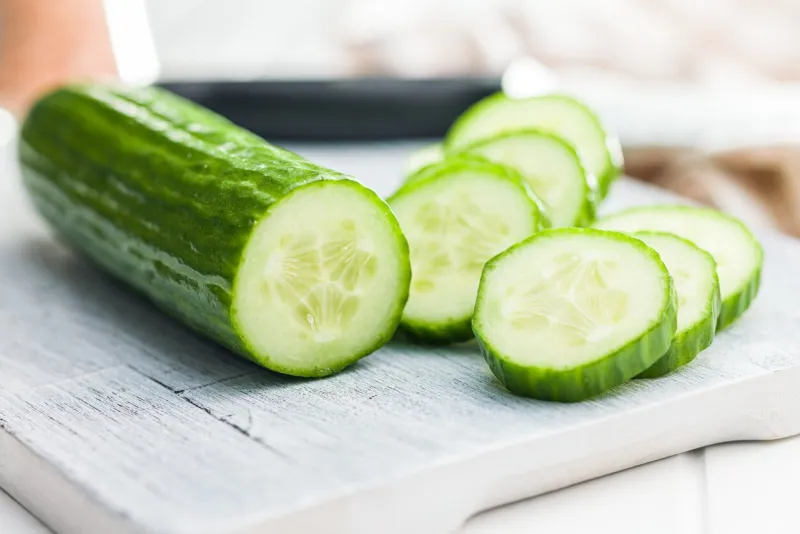 sliced fresh green cucumber on the cutting board