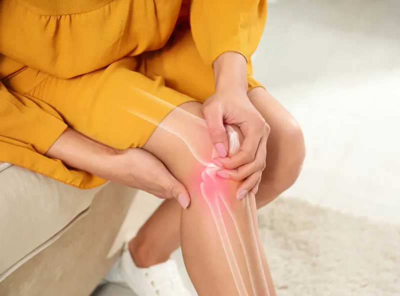 sick woman at home, closeup digital compositing with illustration of knee joint