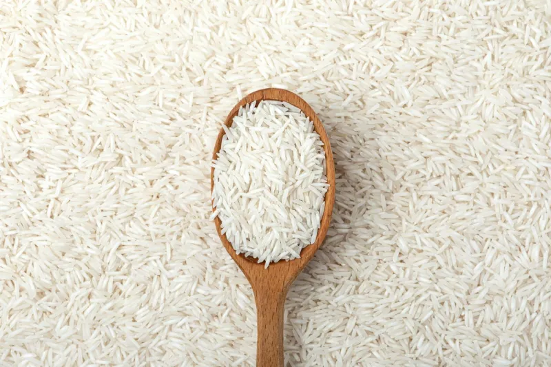 white rice on a wood spoon